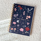 Notebook with floral and celestial design on a textured surface