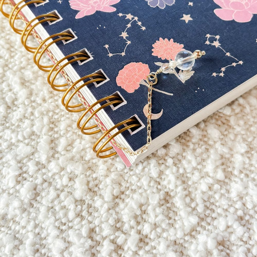 Decorative notebook with a charm on a textured surface