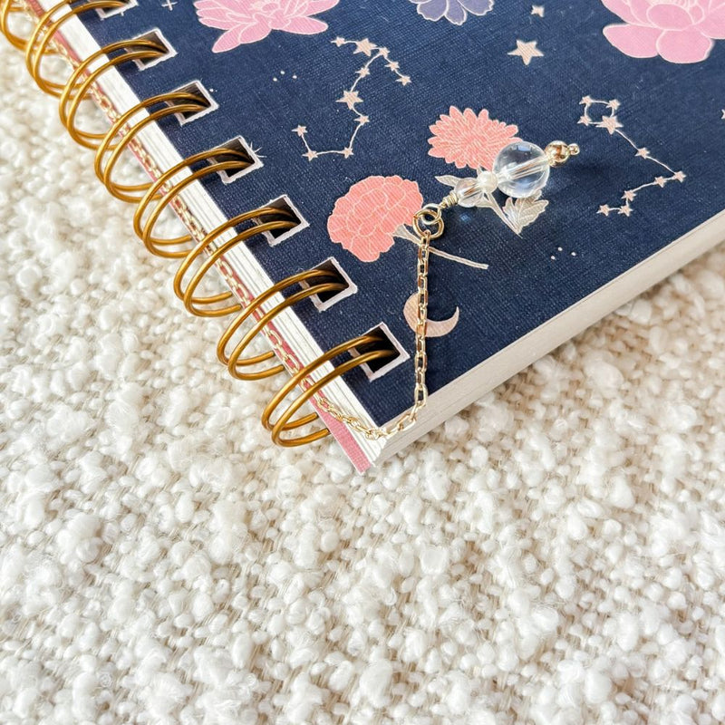 Decorative notebook with a charm on a textured surface